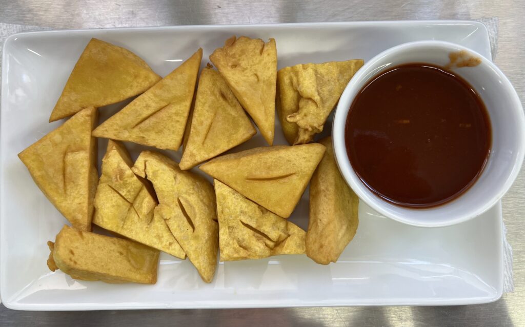 Fried tofu on plate with tamarind sauce
